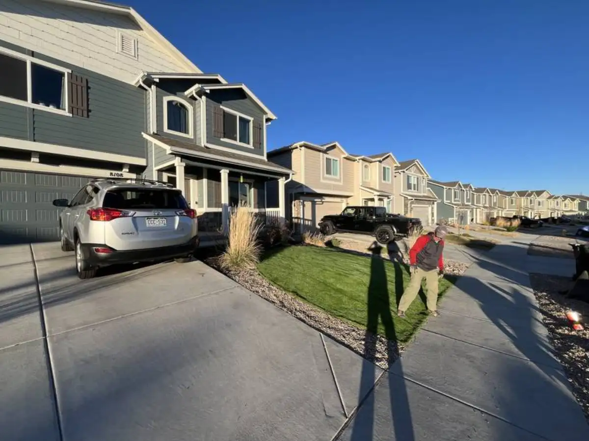 CN Landscaping crew installing artificial turf in a front yard in Colorado Springs