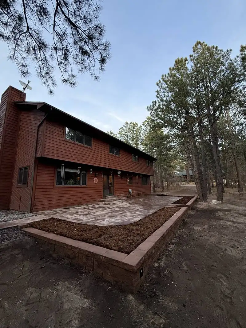 Outdoor living patio with stone features by CN Landscaping in Colorado Springs