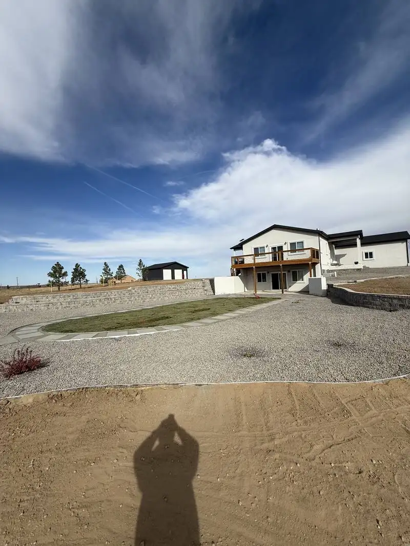 Wide shot of water-wise landscape design with gravel and native plantings in Colorado Springs