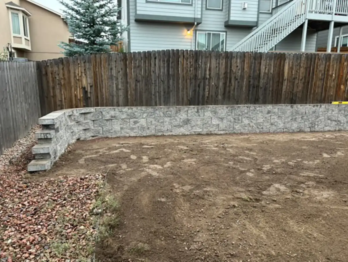 Finished curved segmental-block retaining wall with integrated steps