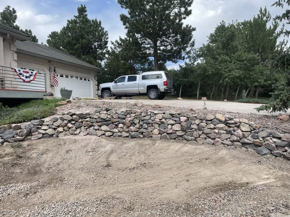 Natural stone retaining wall installation by CN Landscaping in Colorado Springs