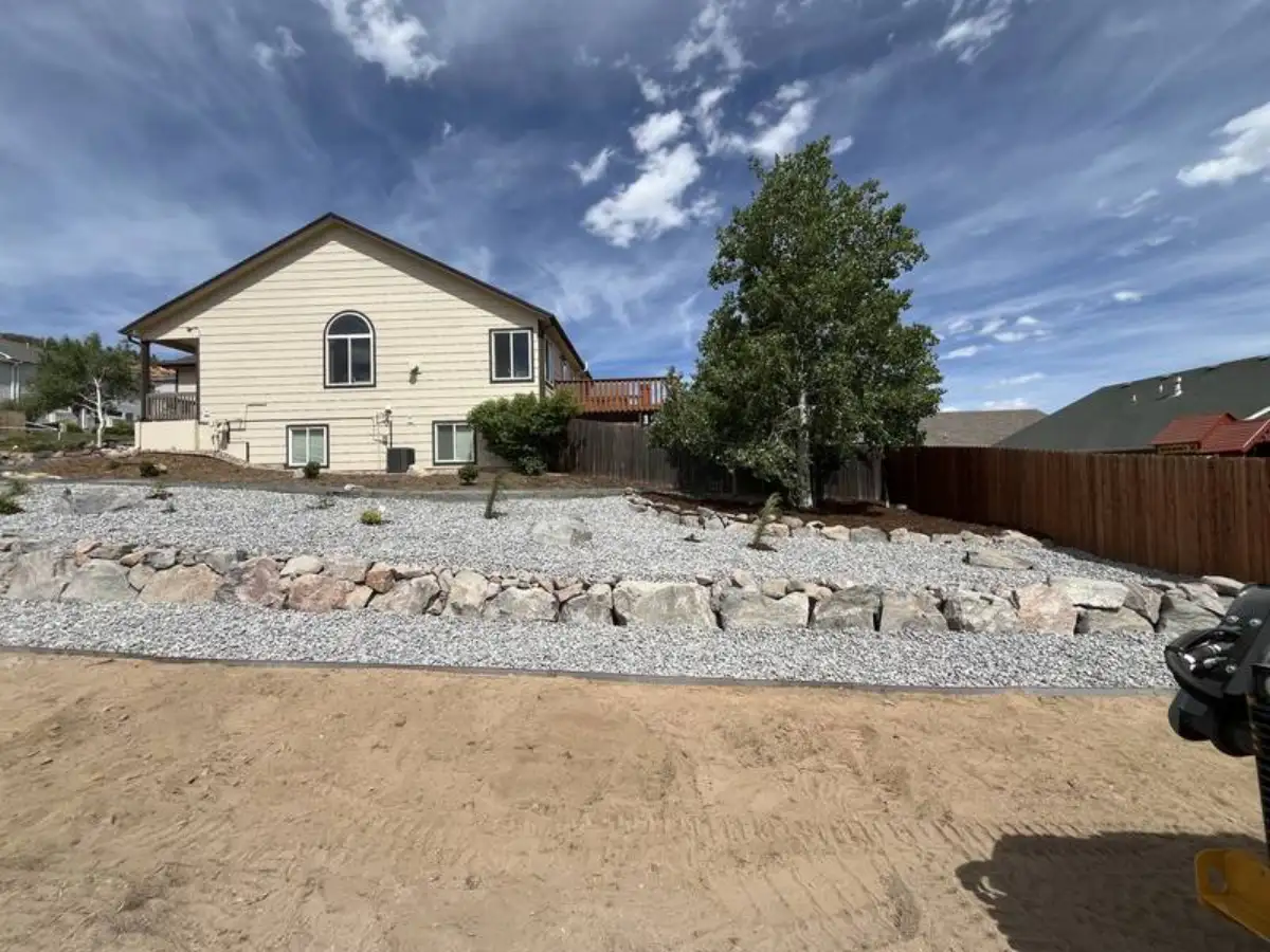 Natural boulder retaining wall with gravel landscaping in Colorado Springs