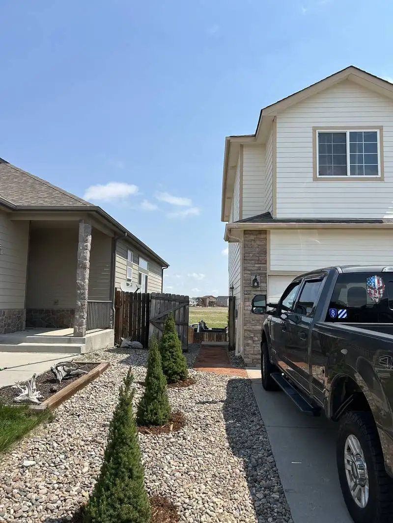 Rock and gravel front yard with evergreen shrubs installed by CN Landscaping