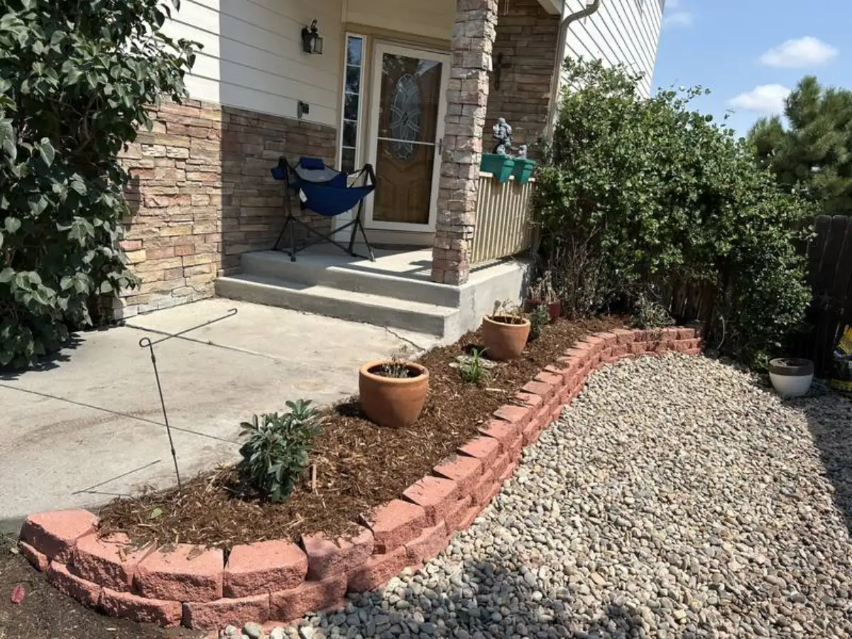 Front entry landscaping with brick border, plantings, and rock in Colorado Springs